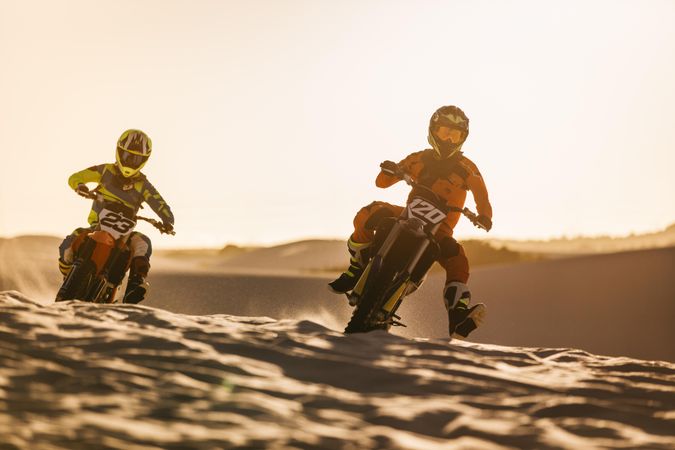 Two motocross racers racing on the off-road circuit