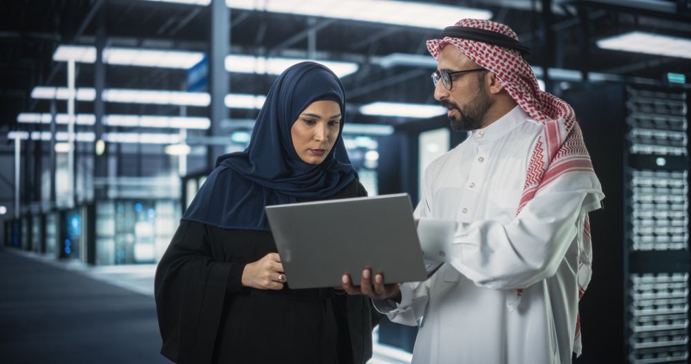 Middle Eastern Network Engineer and Cybersecurity Specialist Work in Server Facility.