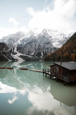 House on stilts on lake near mountains