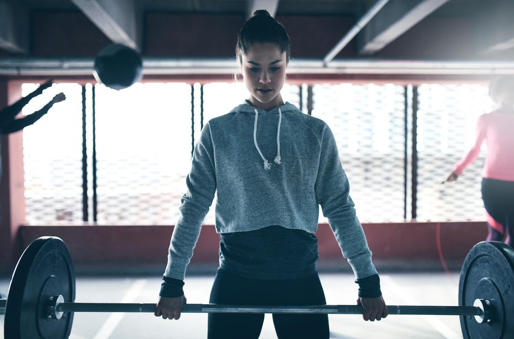 Woman doing weight training in industrial space