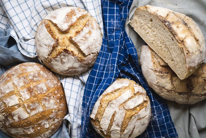 Loaves of sourdough bread on kitchen towels