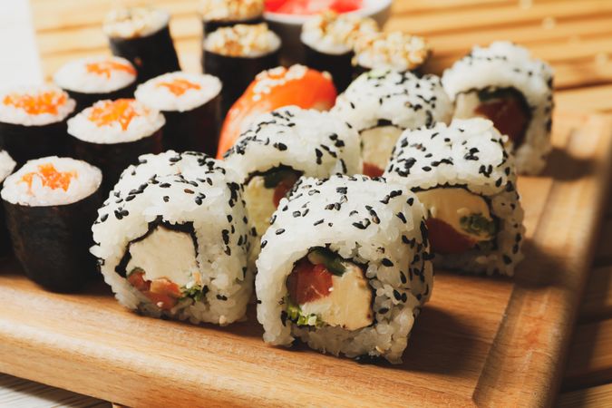 Delicious sushi rolls on wooden background, close up. Japanese food