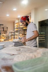 Arabic baker weighting dough with scale