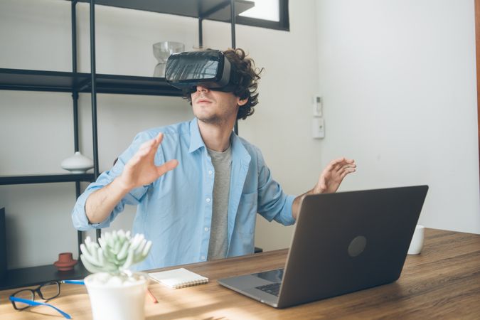 Man at home watching something on VR glasses at home