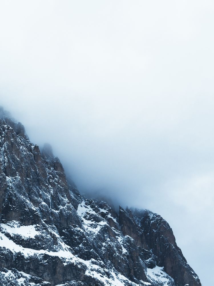 Alpine mountain fading into the clouds