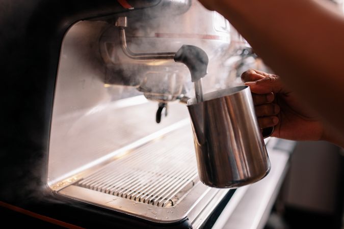 Man making coffee by machine at cafe