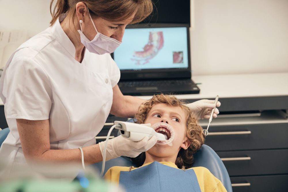 Dentist applying intraoral dental scanner for displaying casts of patient