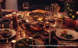 Dining table with comfort food and wine during Christmas dinner 4NrGe4