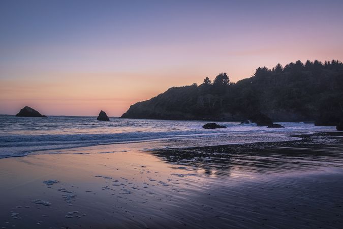 Sunset or sunrise over low tide at a calm beach