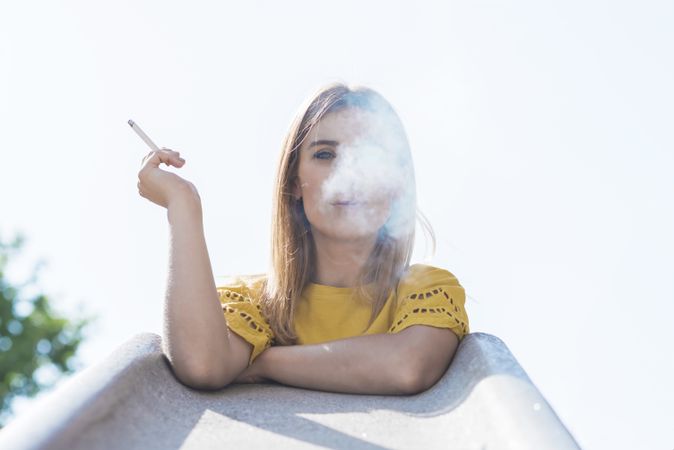 Young woman holding cigarette