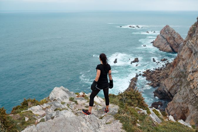 Anonymous female boxer on cliff