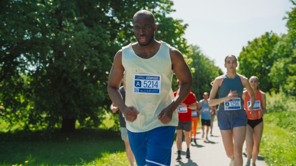 Portrait of a Black Athletic Male Running a Marathon in a City During the Day in Green Park