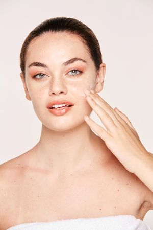 Amiable female taking care of face