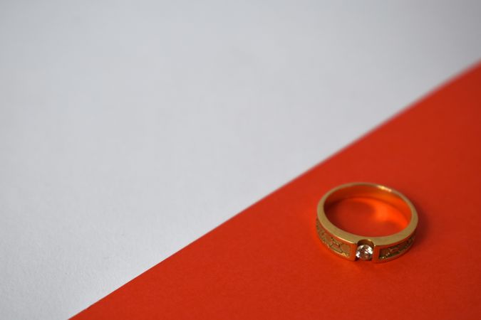 Man's diamond gold ring on duotone background with copy space
