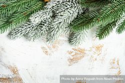 Christmas themed frame with fir tree branches and holiday decoration on rustic background with copy space 4Z8Ox0