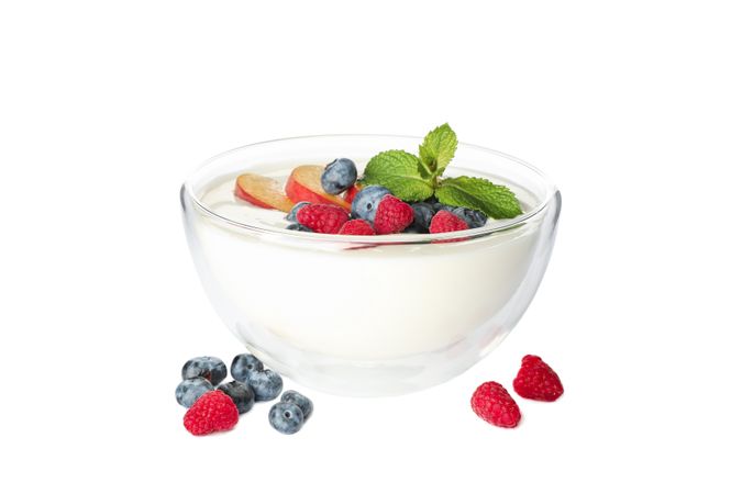 Bowl with sour cream yogurt and fruits isolated on neutral background