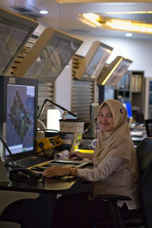 Woman in hijab using desktop computer