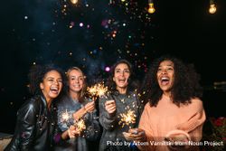 Multi-ethnic group of happy women with sparklers bGBrV4