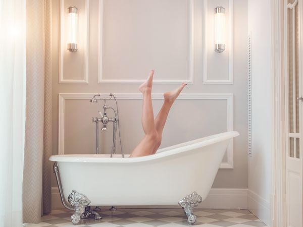 Anonymous woman relaxing in bathtub