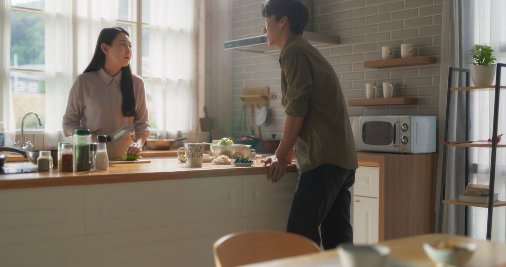 Close Up of a Young Couple Preparing Healthy Vegetarian Food at Home in the Kitchen.