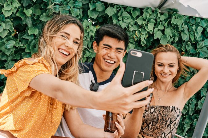 a group of young people making a selfie with last generation mobile phone
