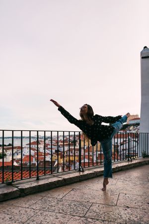 young dancer dancing against cityscape