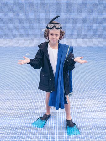 Boy in flippers and mask in empty pool