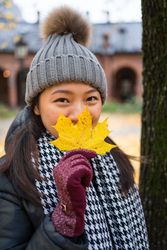 Cheerful young Asian female traveler enjoying sightseeing in Oslo