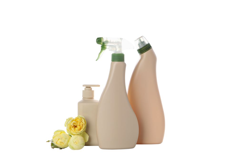 Detergents with brushes and flowers, isolated on plain background