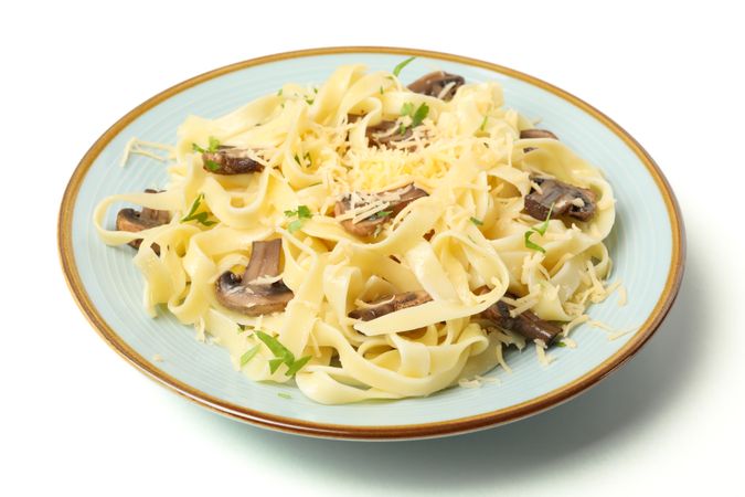 Plate with pasta, cheese and mushrooms isolated on blank background