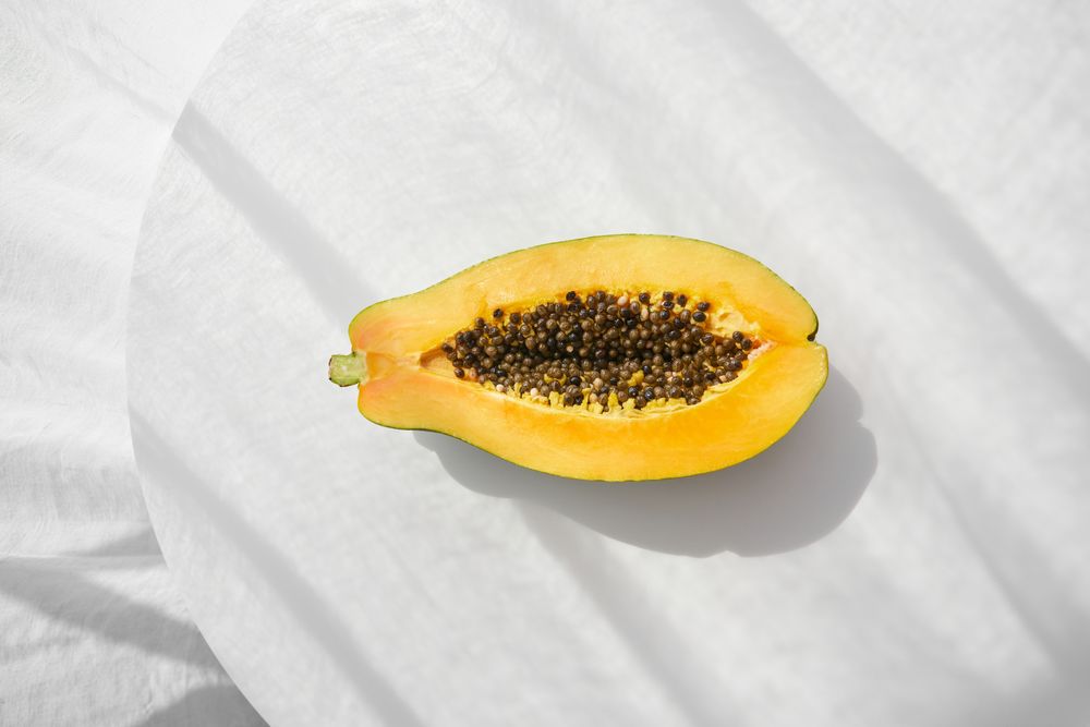 Fresh papaya fruit half placed on table
