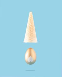 Gold egg with upside down ice cream cone above