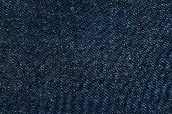 Texture of blue jeans as background, space for text