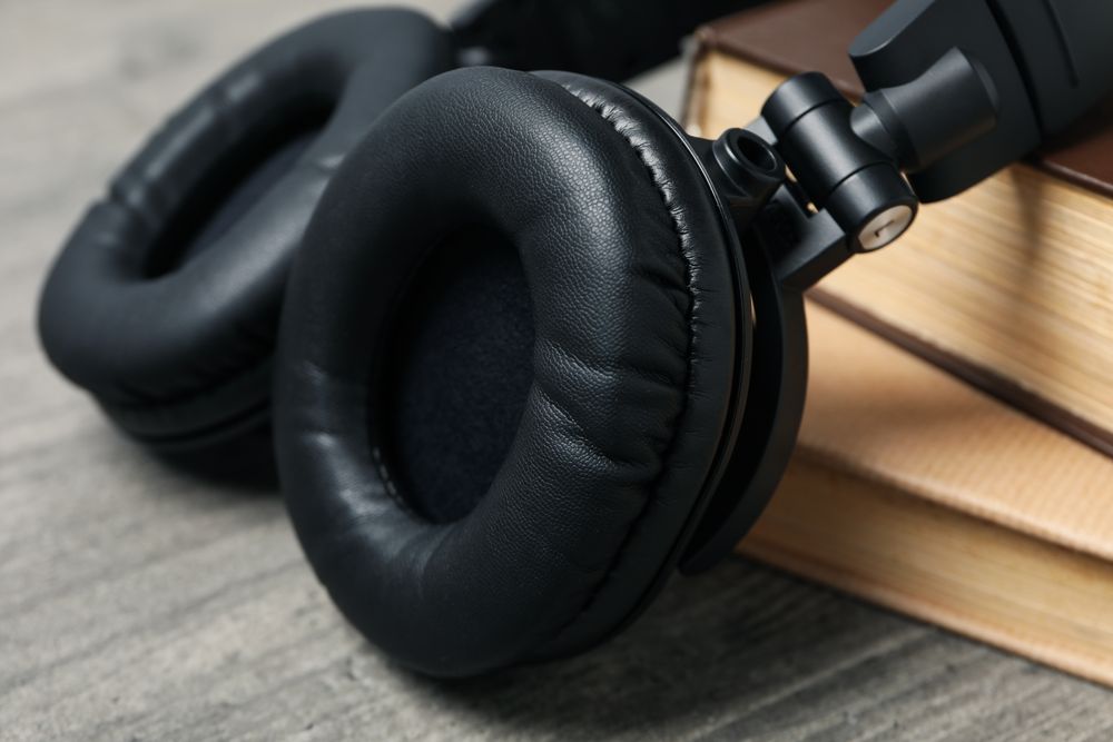 Concept of audiobook with books and headphones