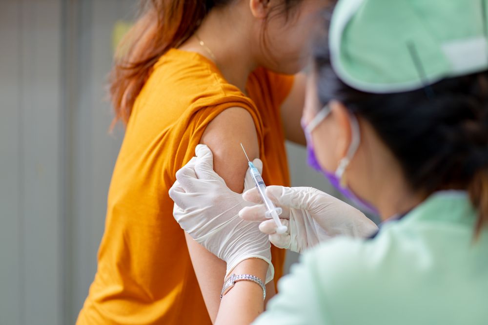Doctor injecting a patient