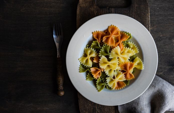 Boiled farfalle pasta in a bowl with copy space
