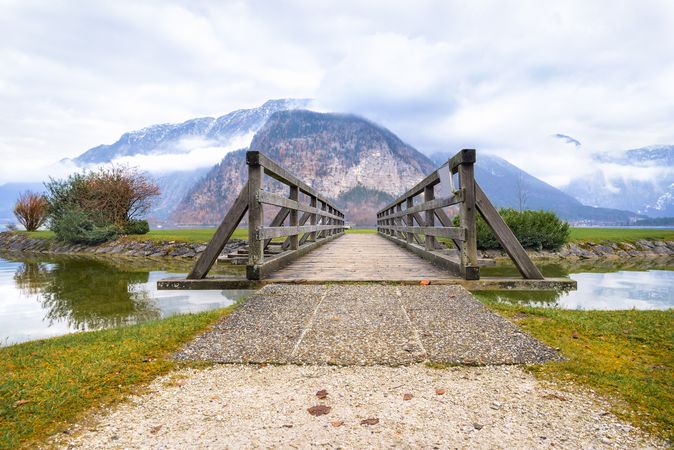 Wooden bridge leading to ale with mountains behind