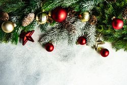 Christmas frame concept with pine branch and red & gold baubles