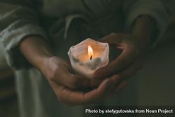 Close up of person holding lit candle 4dXBn4