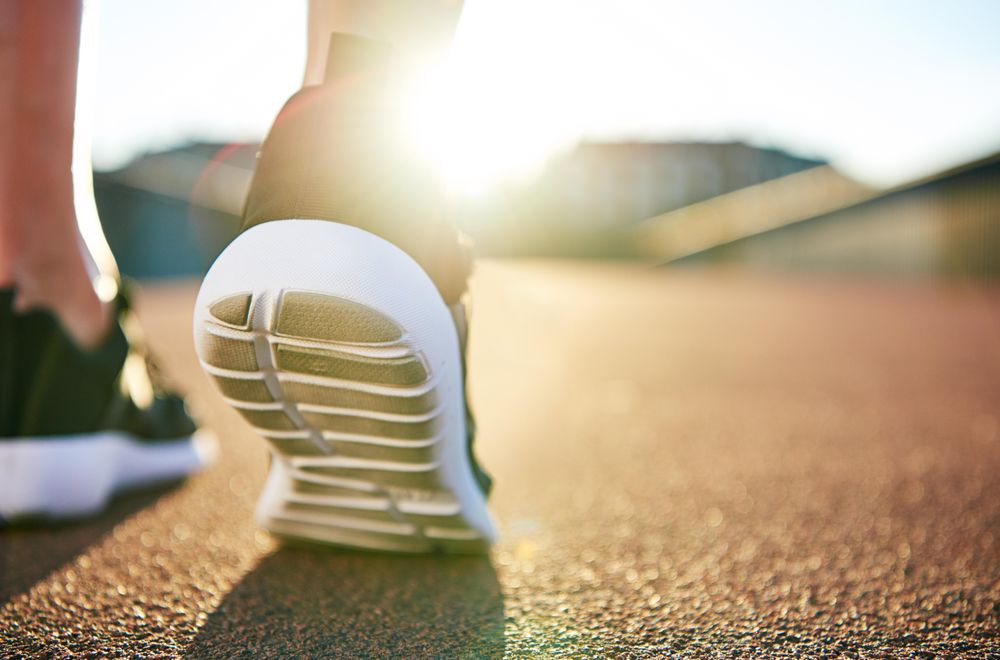 Close up of woman’s training shoes with sunflare