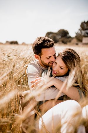 Serene lovers embracing on wheat field