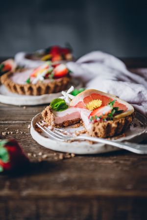 Strawberry and citrus cake served on wooden table