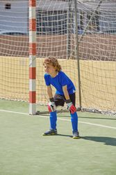 Boy standing at football goal