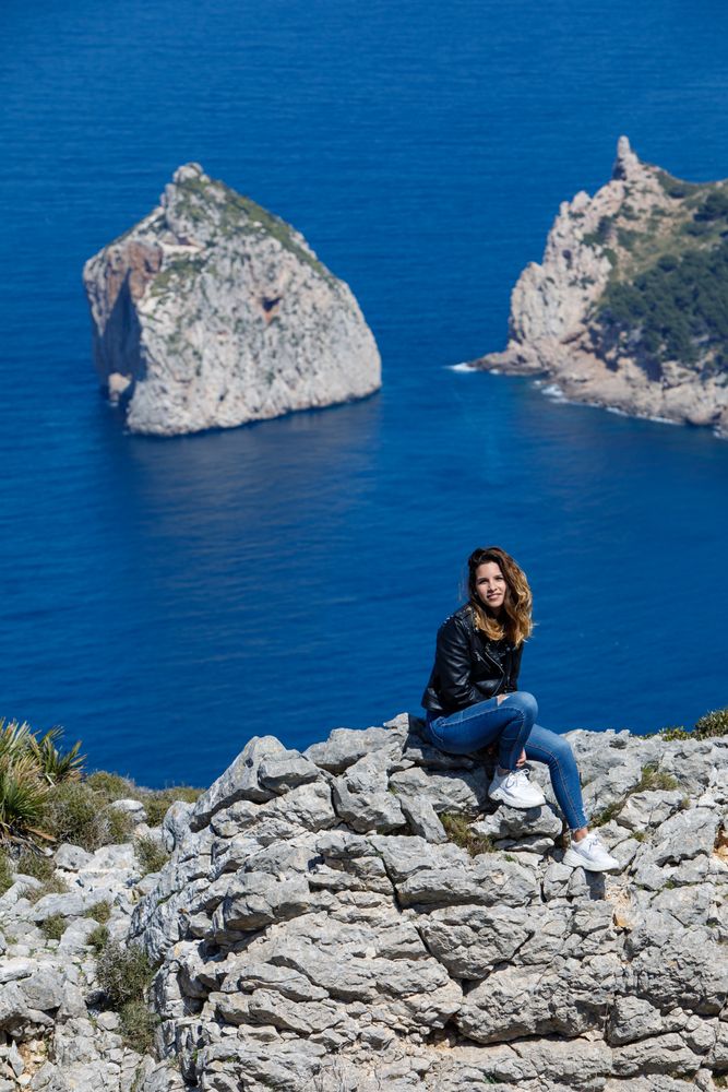 Young woman resting on cliff