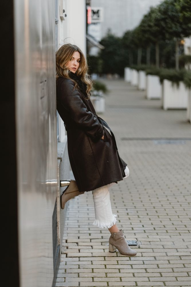 female standing on city street