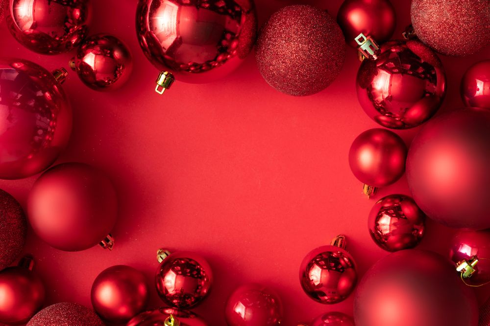Red Christmas baubles decoration on red background