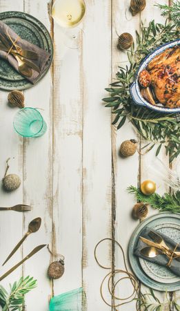 Roast chicken, table setting, decorations of festive fir, arranged on a light background, copy space