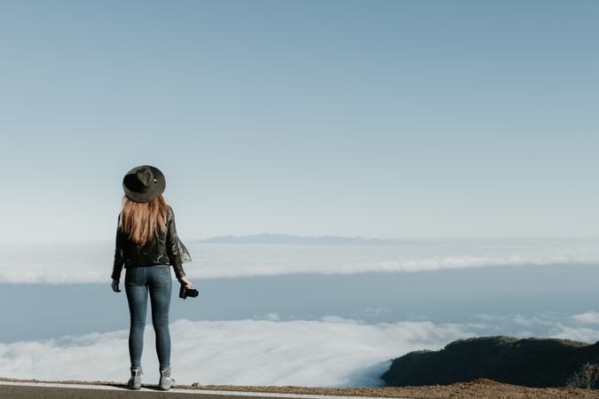 Woman with camera enjoying cloudscape