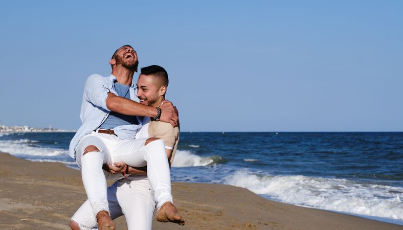 Happy gay couple enjoying and embracing outdoors