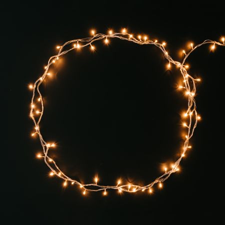 Fairy lights or Christmas lights in circle shape on dark background